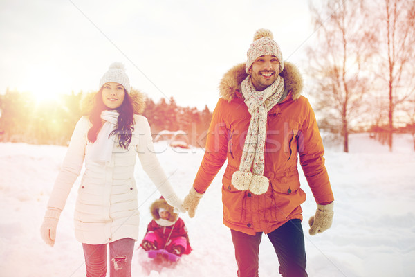 happy family with sled walking in winter outdoors Stock photo © dolgachov