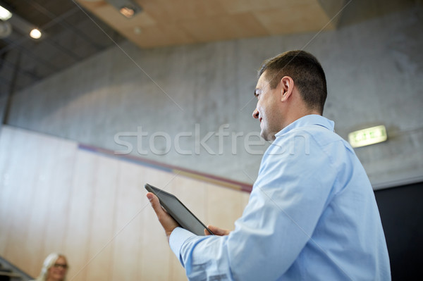 teacher with tablet pc at lecture hall Stock photo © dolgachov