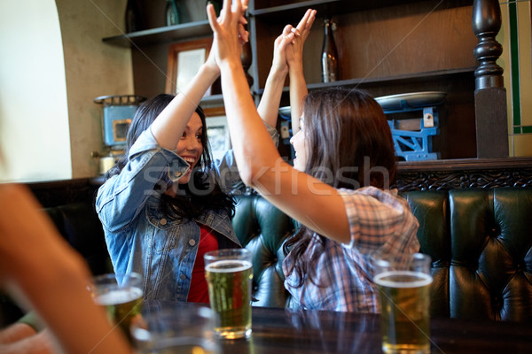 happy friends with beer celebrating at bar or pub Stock photo © dolgachov