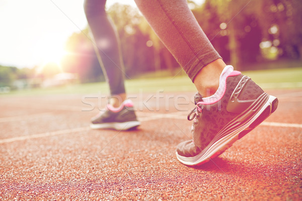 close up of woman feet running on track from back Stock photo © dolgachov