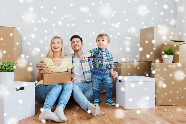 happy family with boxes moving to new home Stock photo © dolgachov