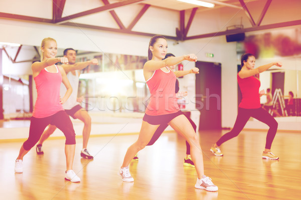 group of smiling people exercising in the gym Stock photo © dolgachov