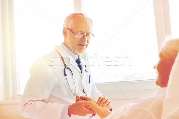 Stock photo: doctor checking senior woman pulse at hospital