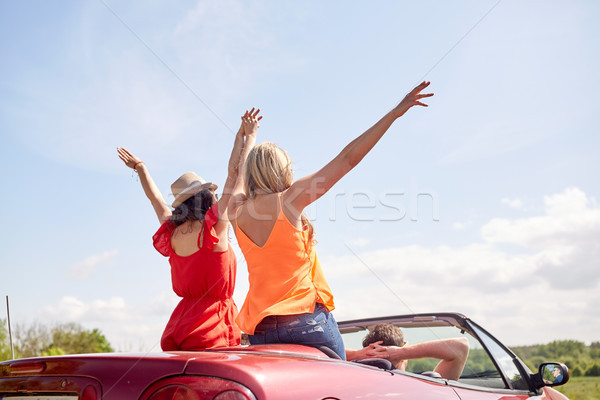 happy friends driving in cabriolet car at country Stock photo © dolgachov