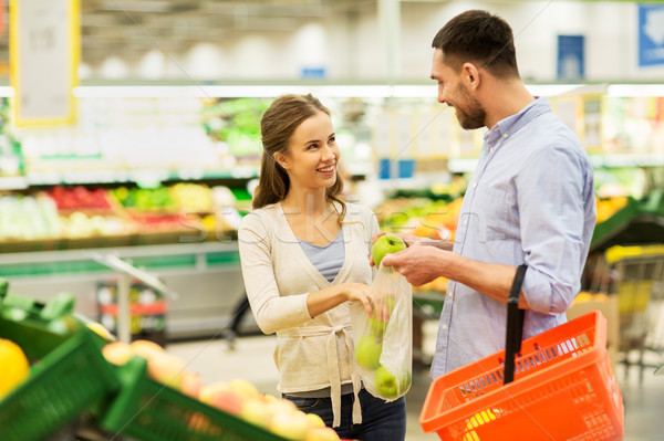 happy couple buying apples at grocery store Stock photo © dolgachov