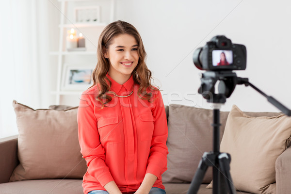 woman with camera recording video at home Stock photo © dolgachov