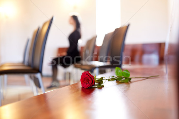 red roses and woman crying at funeral in church Stock photo © dolgachov