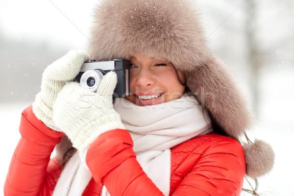 happy woman with film camera outdoors in winter Stock photo © dolgachov