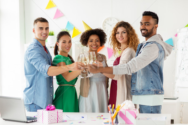 happy team with champagne at office birthday party Stock photo © dolgachov