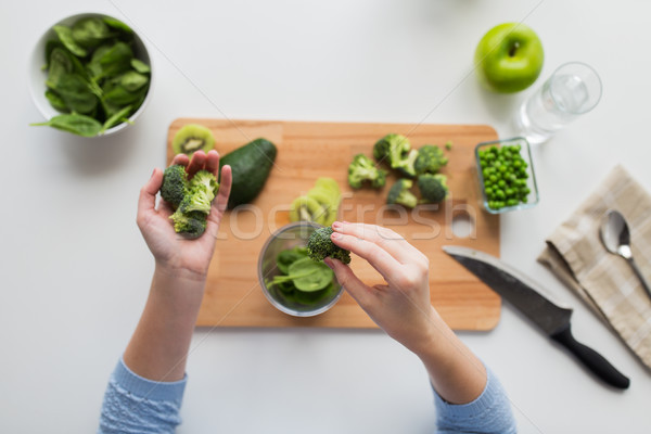 woman hand adding broccoli to measuring cup Stock photo © dolgachov