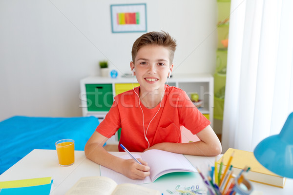 Boldog diák fiú ír notebook otthon Stock fotó © dolgachov