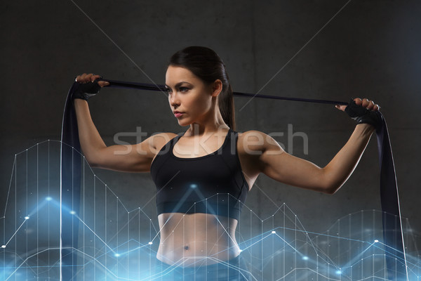 woman with expander exercising in gym Stock photo © dolgachov