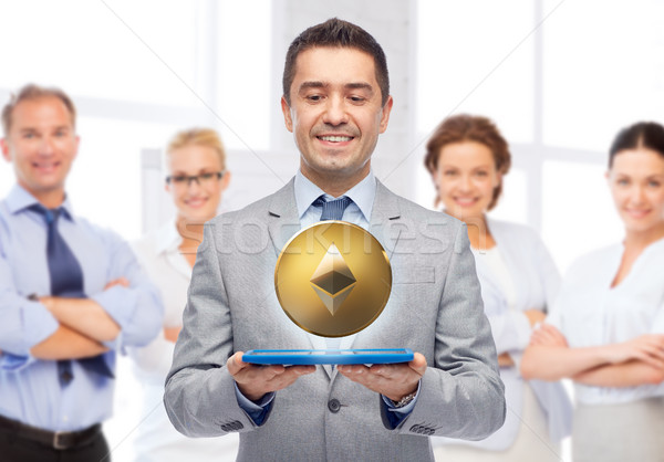 smiling businessman with etherum over tablet pc Stock photo © dolgachov