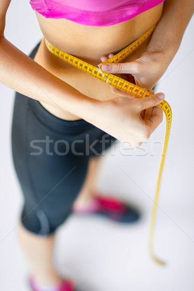 trained belly with measuring tape Stock photo © dolgachov