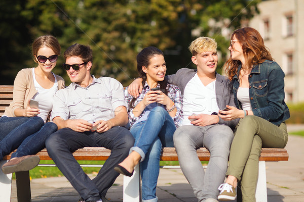 students looking at smartphones and tablet pc Stock photo © dolgachov