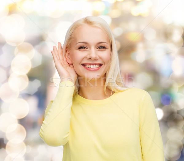 smiling young woman listening to gossip Stock photo © dolgachov