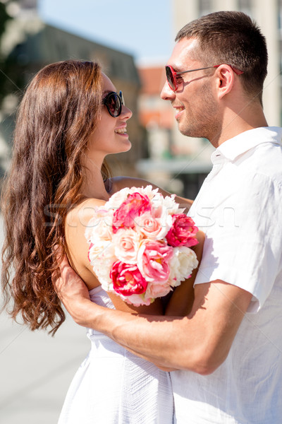 smiling couple in city Stock photo © dolgachov