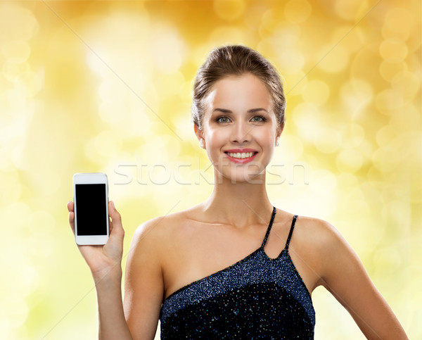 улыбающаяся женщина вечернее платье смартфон технологий связи реклама Сток-фото © dolgachov