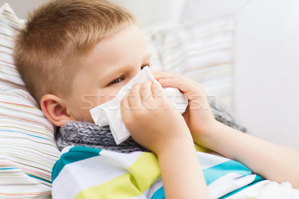 ill boy with flu at home Stock photo © dolgachov