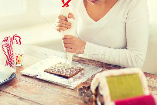 close up of woman making gingerbread houses Stock photo © dolgachov