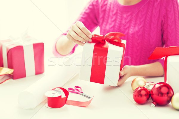 close up of woman decorating christmas presents Stock photo © dolgachov