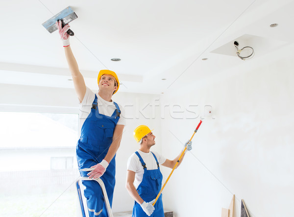 group of builders with tools indoors Stock photo © dolgachov