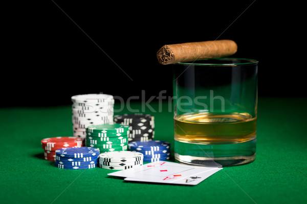 close up of chips, cards whisky and cigar on table Stock photo © dolgachov