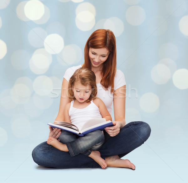 happy mother with adorable little girl and book Stock photo © dolgachov