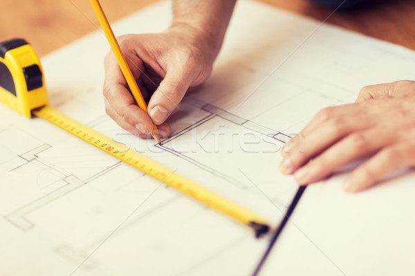 close up of male hands making changes to blueprint Stock photo © dolgachov