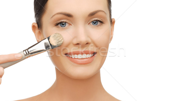 woman applying liquid foundation with brush Stock photo © dolgachov