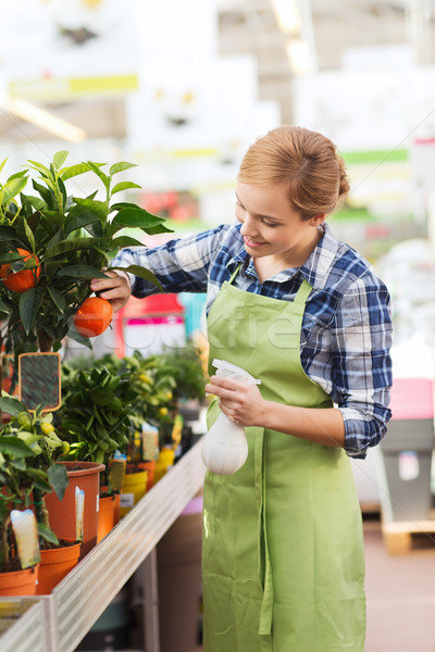 happy woman touching mandarin tree in greenhouse Stock photo © dolgachov