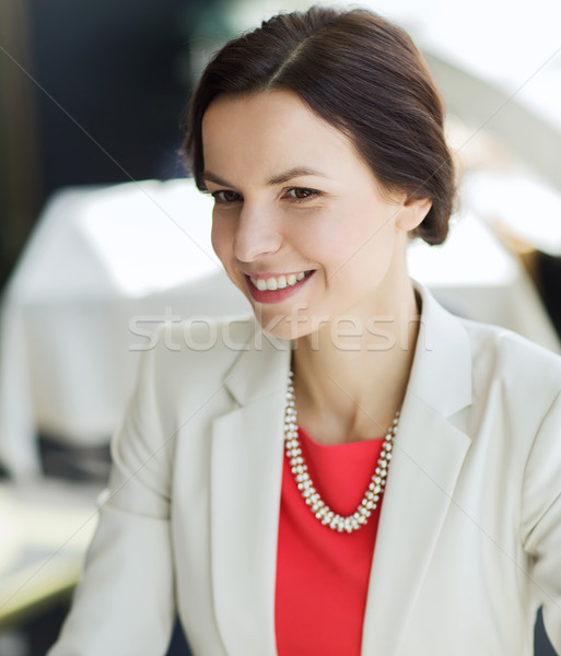 happy woman sitting at table in restaurant Stock photo © dolgachov