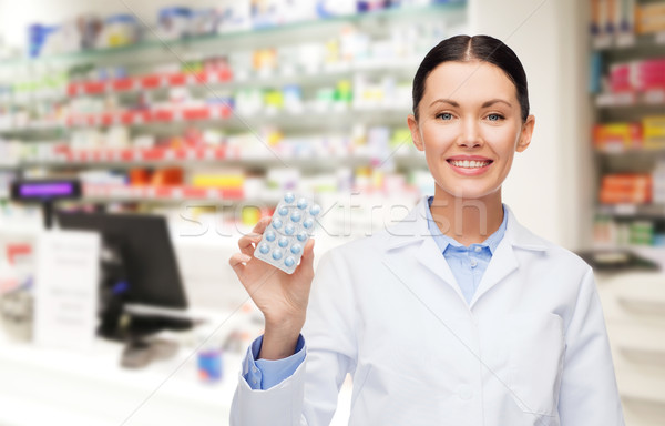 woman pharmacist with pills drugstore or pharmacy Stock photo © dolgachov