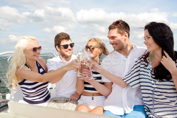 Souriant amis verres champagne yacht vacances Photo stock © dolgachov