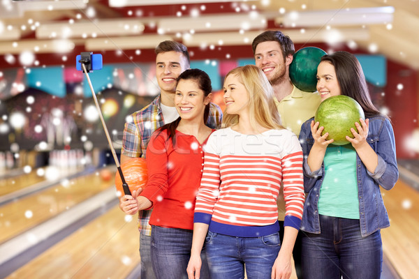 happy friends taking selfie in bowling club Stock photo © dolgachov