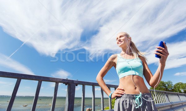 happy woman with smartphone and earphones outdoors Stock photo © dolgachov