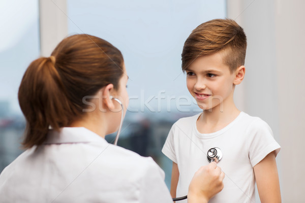 doctor with stethoscope listening to happy child Stock photo © dolgachov