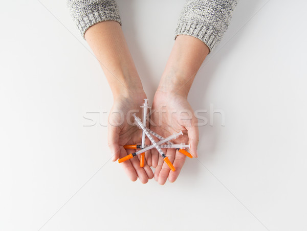 close up of woman hands holding syringes Stock photo © dolgachov