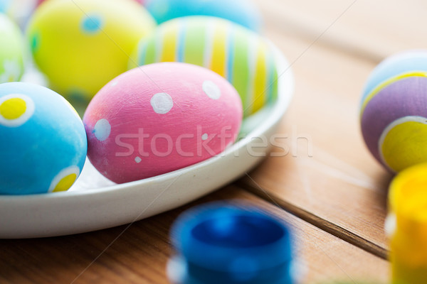 close up of colored easter eggs on plate Stock photo © dolgachov