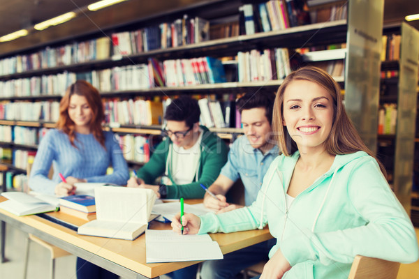 Stockfoto: Gelukkig · student · meisje · schrijven · notebook · bibliotheek