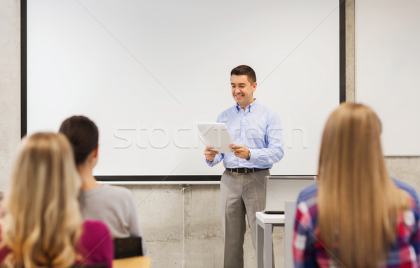 group of students and teacher with notepad Stock photo © dolgachov