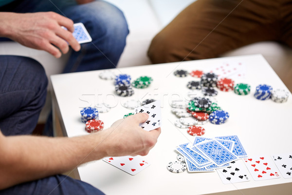 close up of male friends playing cards at home Stock photo © dolgachov