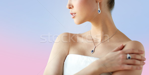 beautiful woman with earring, ring and pendant Stock photo © dolgachov