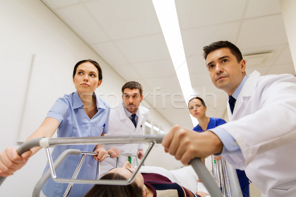 medics with woman on hospital gurney at emergency Stock photo © dolgachov