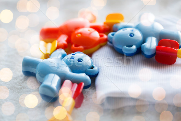 close up of baby rattle and clothes for newborn Stock photo © dolgachov