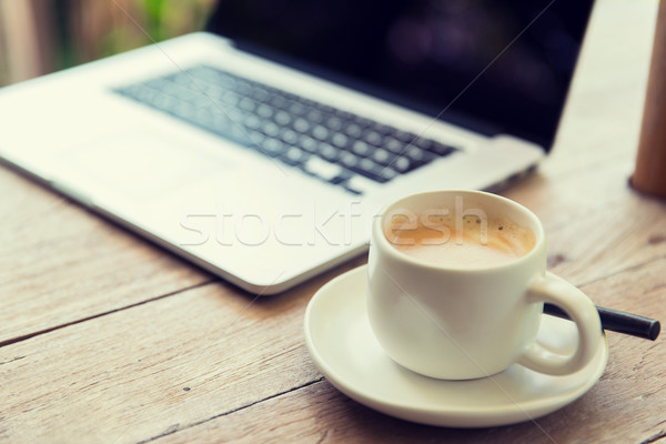 close up of laptop and coffee cup on office table Stock photo © dolgachov