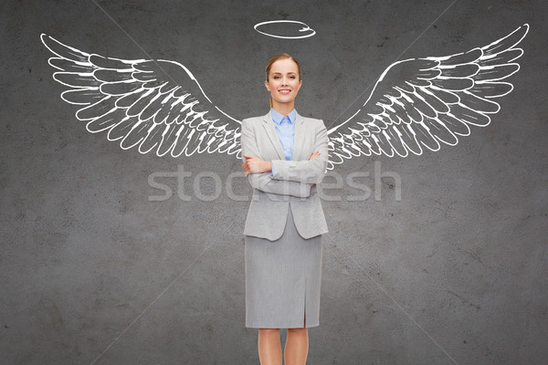 Stock photo: happy businesswoman with angel wings and nimbus