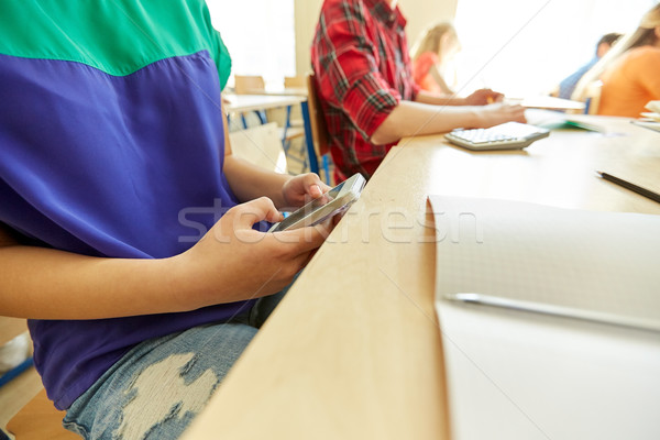student girl with smartphone texting at school Stock photo © dolgachov