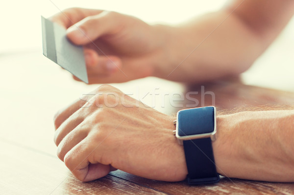 close up of hands with smart watch and credit card Stock photo © dolgachov