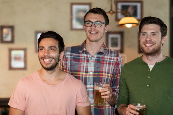 happy male friends drinking beer at bar or pub Stock photo © dolgachov